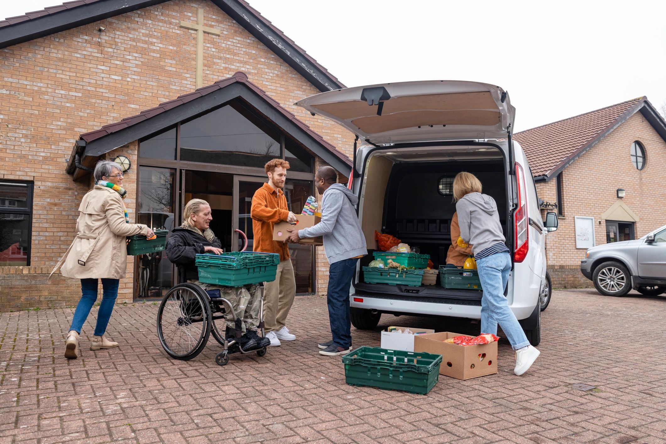 Community volunteers unloading food donations together