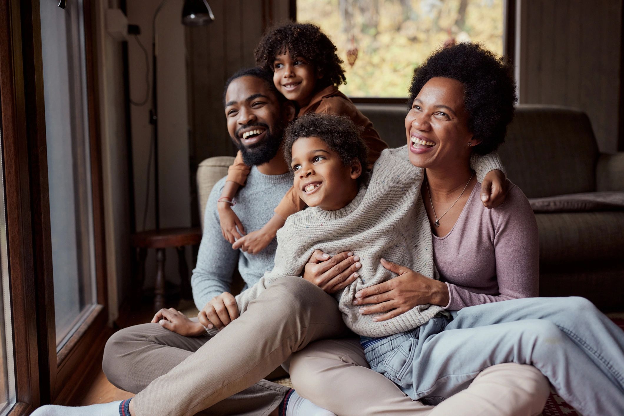 Parents and children spending time together in a living room