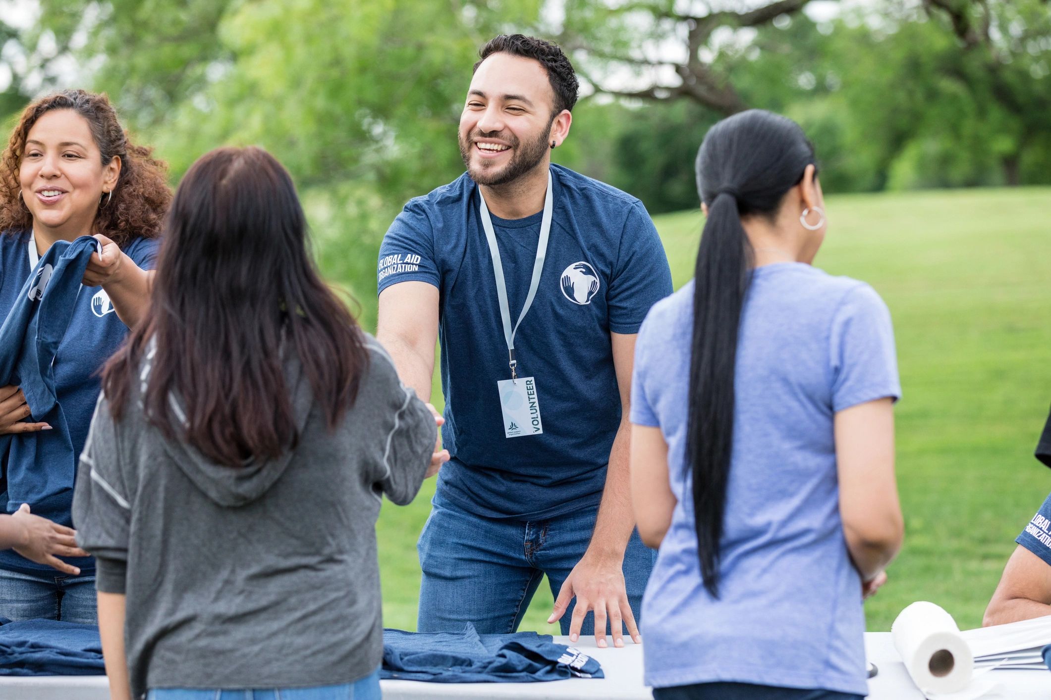 Volunteer greeting a community member in a park
