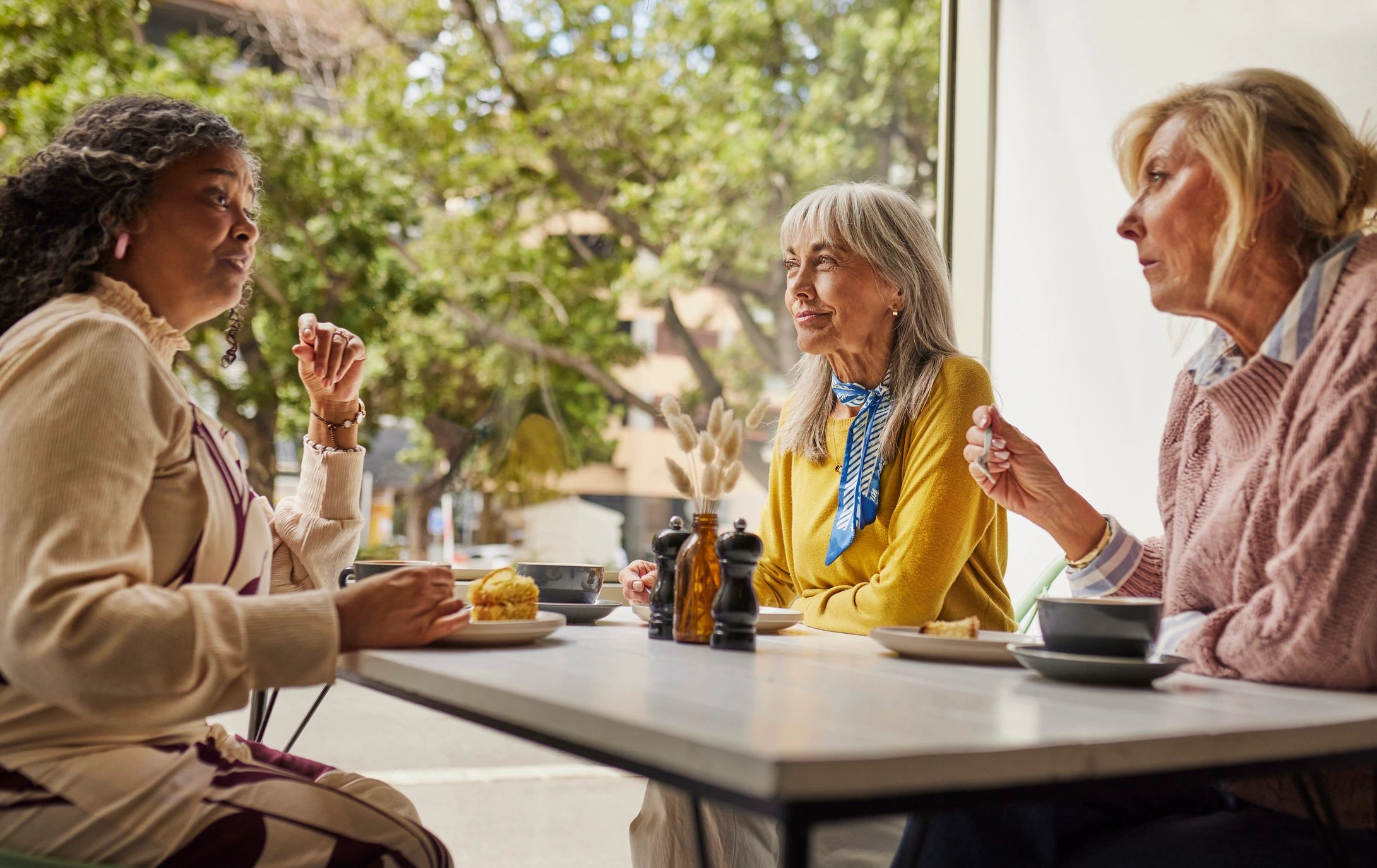 Senior women in conversation at a community table